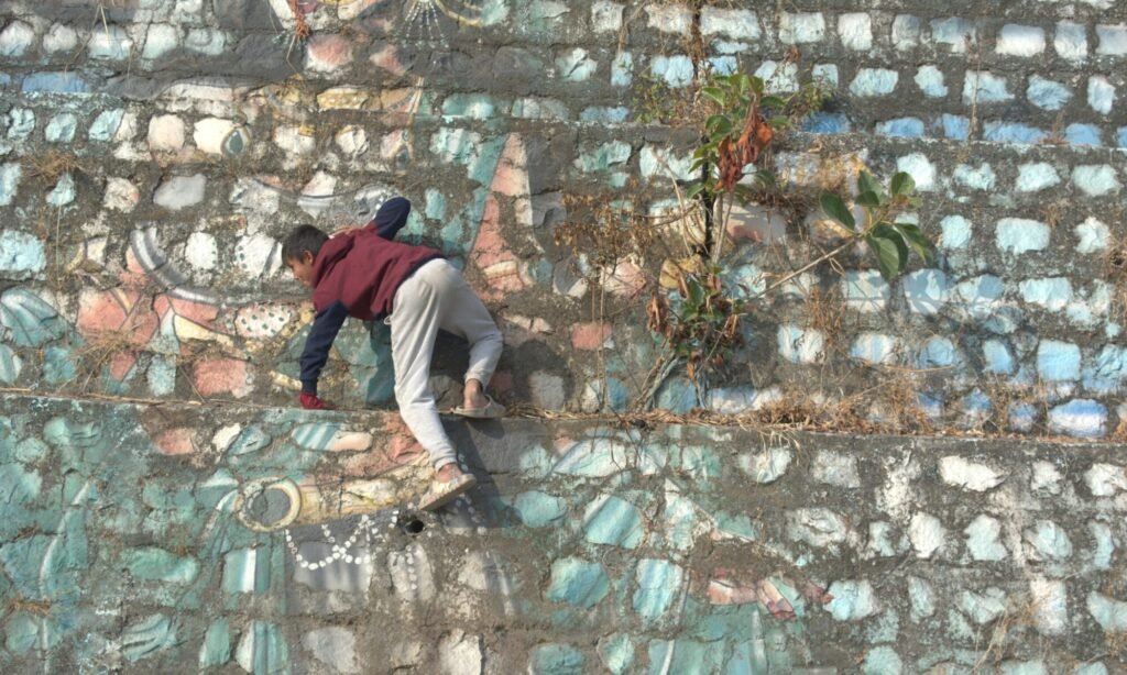 a kid climbing a wall